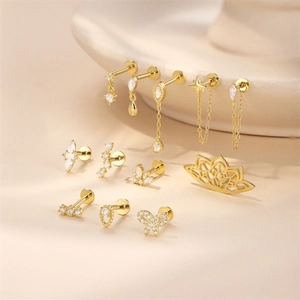 Detailed close-up of S925 silver lotus stud earrings set with gold tassels and crystals