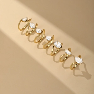 Detail of geometric S925 silver gold rings with various diamond cuts and cross band