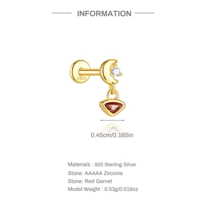 Detail of s925 silver moon stud earring with white zircon and red garnet stone pendant