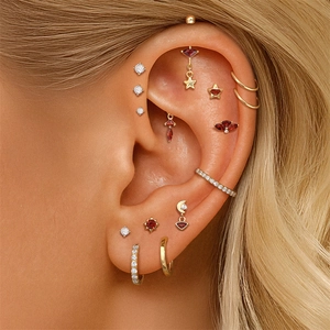 Detailed view of S925 silver ear cuff set with red garnets and geometric studs