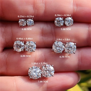 Macro view of five sizes of S925 sterling silver moissanite stud earrings on a palm