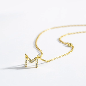 Close-up of 18K gold S925 silver necklace with sparkling zircon-set letter M pendant