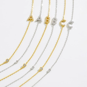 Close-up of S925 silver alphabet necklaces in gold and silver with cubic zirconia