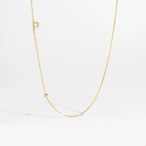 Detailed view of gold S925 silver necklace with sparkling zircon Letter P and single round gem