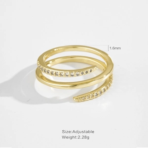 Macro detail of gold triple-layer spiral ring with S925 hallmark and zircon inlay