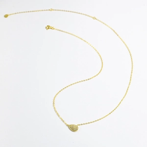 Detail of S925 sterling silver stamp on golden pear-shaped pavé droplet pendant necklace