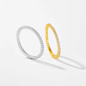 Macro shot of silver and gold eternity bands with full-circle cubic zirconia stones