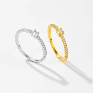 Detail of silver and gold S925 rings showing clear metal stamps and round zircon stones
