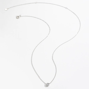 Macro detail of S925 sterling silver necklace with round white stone pendant