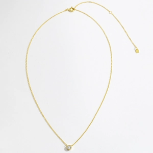 Detail of gold S925 sterling silver cross chain with round white stone pendant and extender