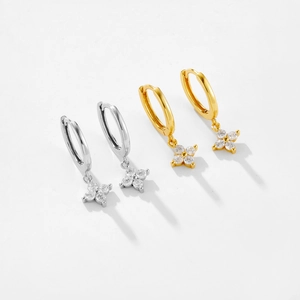 Detail of S925 silver flower drop earrings with four cubic zirconia stones in gold and silver