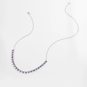 Macro detail of S925 silver necklace featuring faceted round purple stones and spring clasp