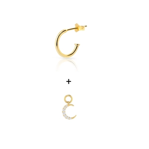 Macro detail of gold C-shaped earring and crescent moon pendant with zircon stones
