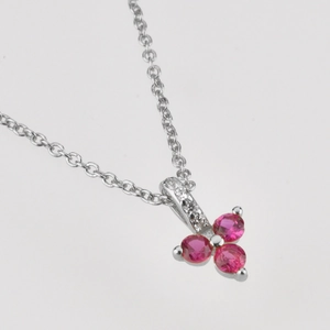 Macro view of S925 silver necklace with rose red stones and sparkling zircon petals