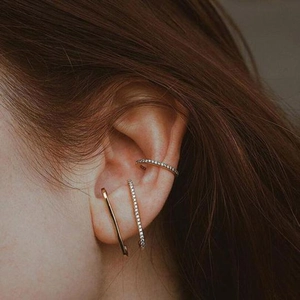S925 Gold C-Shaped earrings set with pavé cubic zirconia on model's ear in close-up view