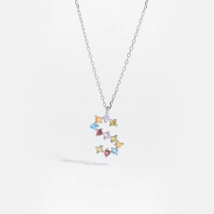 Macro shot of silver S-letter pendant featuring vibrant multi-colored cubic zirconia gems