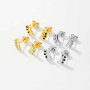 Detailed macro view of S925 sterling silver crescent earrings in gold and silver set