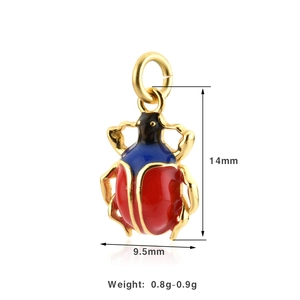 Detailed view of beetle pendant with red and blue enamel coating in gold finish