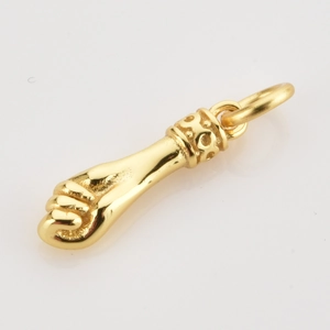 Detailed view of a gold-plated fist-shaped charm with intricate hollowed patterns