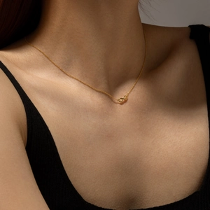 Elegant gold infinity symbol necklace in S925 silver worn on neck for minimalist style