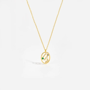 Macro shot of gold constellation necklace with colorful zircons on white background