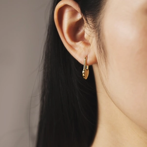 S925 sterling silver gold heart lock earrings worn by a model in a close-up shot