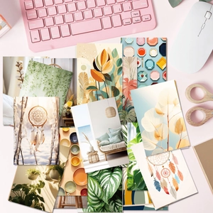 Flat lay of Nordic aesthetic postcards on a pink desk with a keyboard and mouse