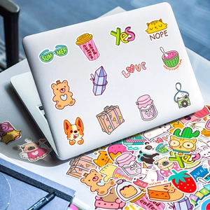 Close-up of waterproof cartoon stickers on a white laptop with cute animal designs