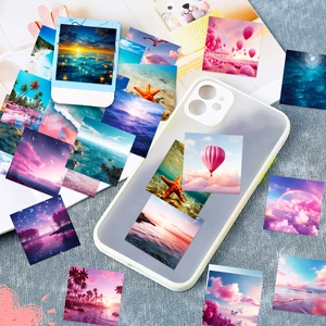 Close-up of aesthetic landscape stickers with sunset and stars on a phone case
