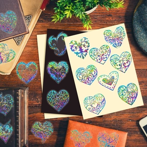 Detailed view of heart-shaped holographic laser stickers with rainbow shimmer and floral patterns