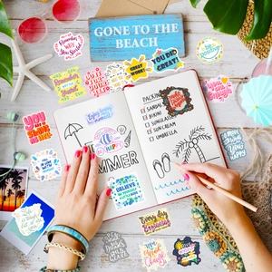 Close-up of inspirational quotes stickers used for scrapbooking on a desk setup