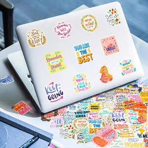 Detail of vibrant waterproof motivational quote stickers on laptop and water bottle surface