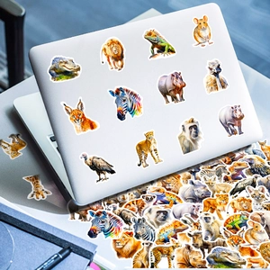 Detailed realistic African animal stickers applied to a sleek silver laptop surface