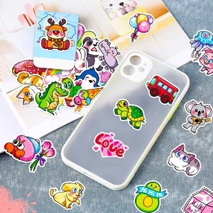 Variety pack of colorful cartoon stickers decorating a clear phone case and magazine