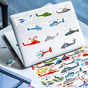 Detail of cool helicopter and airplane stickers applied to a silver laptop cover