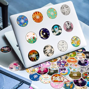 Close-up of retro music record stickers on a white laptop surface for creative decoration