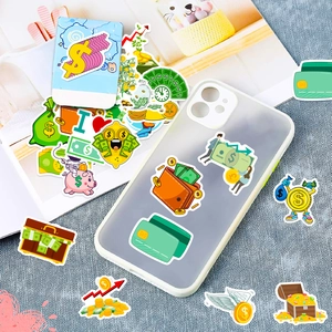 Close-up of wealth themed stickers applied to a phone case on a blue textured surface