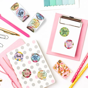 Close-up of pink floral Thank You stickers on stationery for gift packaging