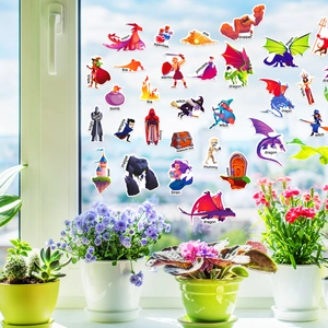 Detail of colorful fantasy dragon stickers applied on a bright window with plants
