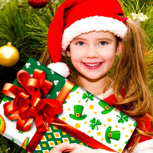 Detail of St. Patrick’s Day themed gift box with green clover patterns and a red satin bow