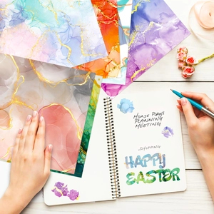 Detailed flatlay of colorful marble scrapbooking paper with gold foil for DIY crafts