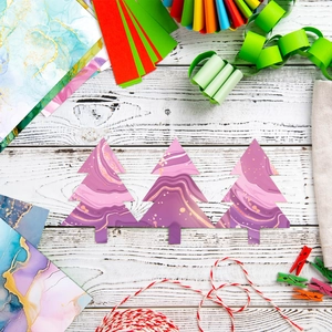 Close-up of marble texture Christmas tree paper tags with gold glitter for DIY crafts
