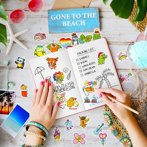 Detailed view of cute cartoon animal stickers used for decorating a summer travel journal