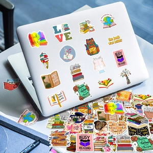 Close-up of reading themed stickers on laptop featuring creative book illustrations