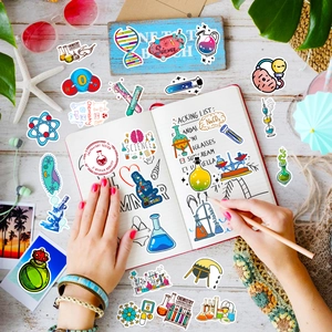 Flat lay of colorful science lab stickers with DNA, microscopes and chemistry flasks