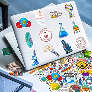 Close-up of scientific stickers including flasks and DNA on a silver laptop back