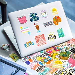 Close-up of colorful motivational vinyl stickers applied on a white laptop lid