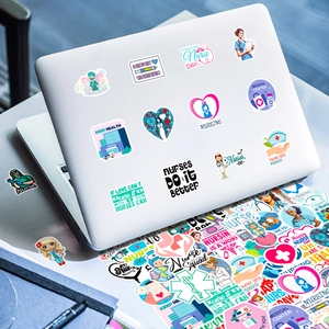 Close-up of nurse themed cartoon stickers applied on a silver laptop backplate surface