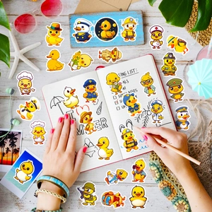 Close-up of diverse cartoon rubber duck stickers on a notebook with summer accessories