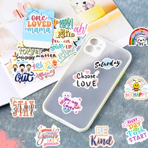 Detailed view of colorful motivational stickers applied to a white phone case cover